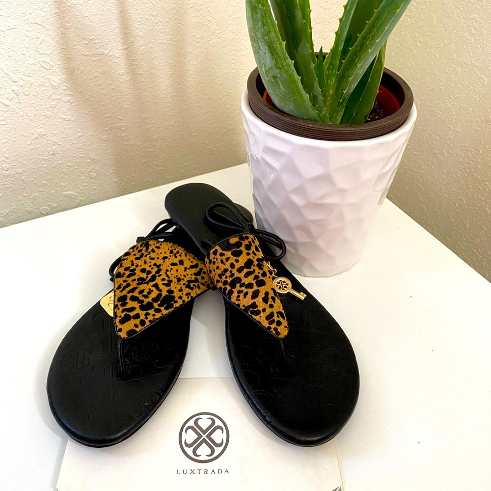 Leather, black and brown leopard color. Soft and comfortable.